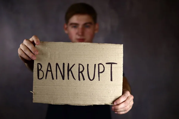 Young Man Holds Poster Cardboard Text Bankrupt — Stock Photo, Image