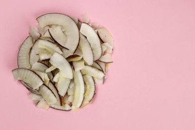 Pembe arka planda hindistan cevizi parçacıkları üst görünüm