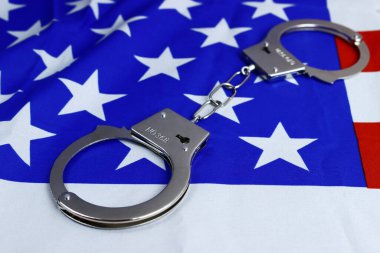 Amerika bayrağında kelepçe, suçla mücadele konsepti, ABD 'de yolsuzluk.