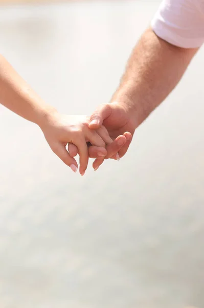 Couple Holding Hands Light Background Vertical Orientation — стоковое фото