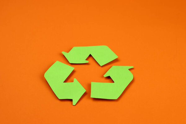Icon of recycling made of green paper, the concept of protection, preservation of the environment