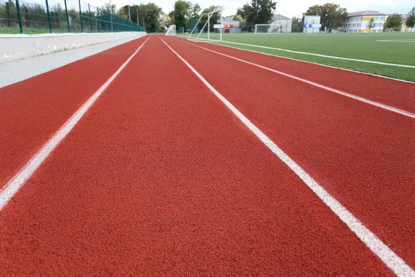 Red treadmill on sport field. Running track on the stadium with rubber coating
