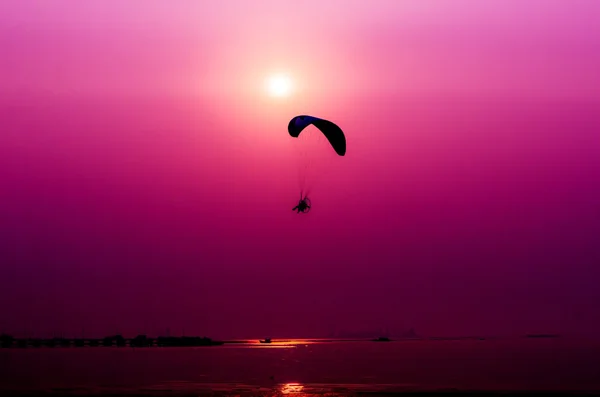 Paramotor flying on sunset background — Stock Photo, Image