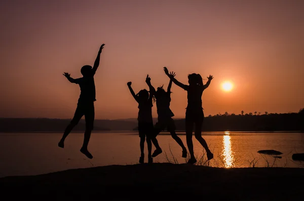 Silhouette family jumping — Stock Photo, Image