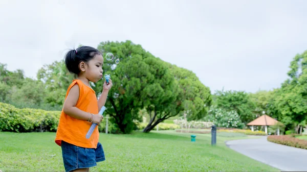 Азиатская девочка играет в пузырь — стоковое фото