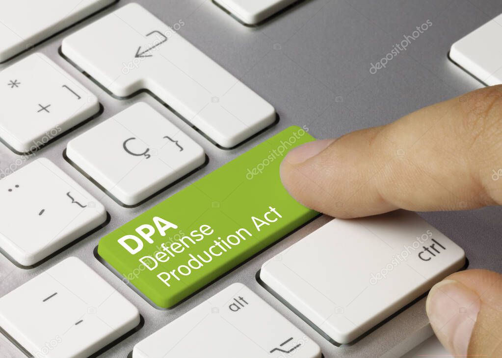DPA Defense Production Act Written on Green Key of Metallic Keyboard. Finger pressing key.