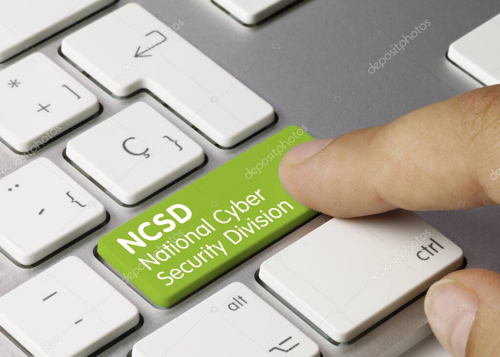 NCSD National Cyber Security Division Written on Green Key of Metallic Keyboard. Finger pressing key.
