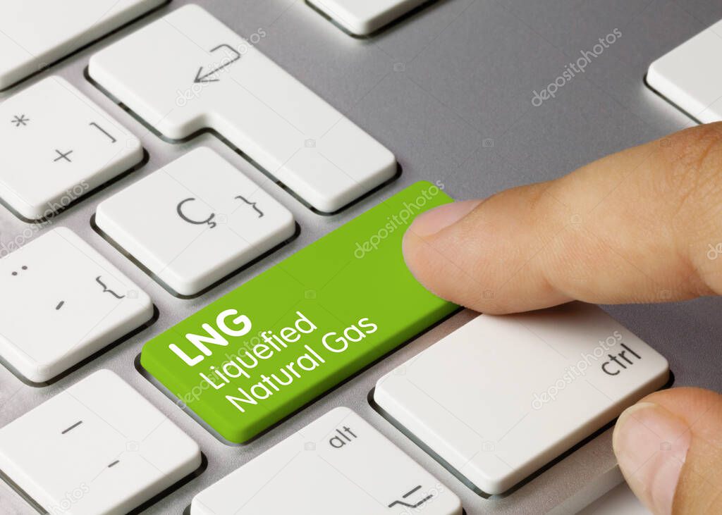 LNG Liquefied Natural Gas Written on Green Key of Metallic Keyboard. Finger pressing key.