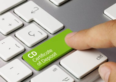 CD Certificate of Deposit Written on Green Key of Metallic Keyboard. Finger pressing key.
