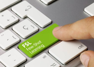 FSL Few-Shot Learning Written on Green Key of Metallic Keyboard. Finger pressing key.