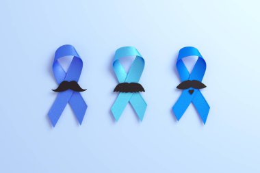 Three blue ribbons with moustache and copy space isolated on a blue background for Blue November and Prostate Cancer Awareness Month flyer template in 3D rendering clipart
