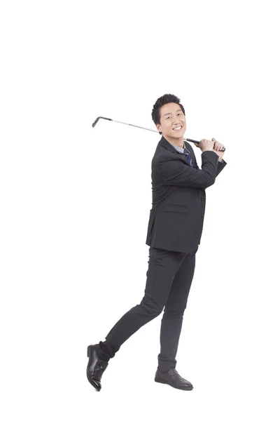 Business man holding golf swing — Stock Photo, Image