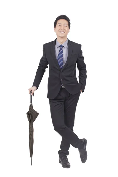 Бизнесмен держит зонтик — стоковое фото