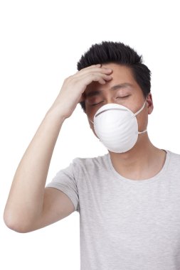 Asyalı adam maske takıyor.