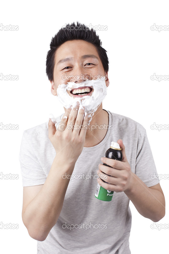 Asian man shaving