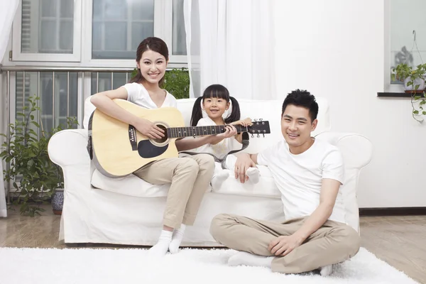 Mladá rodina hrát na kytaru — Stock fotografie