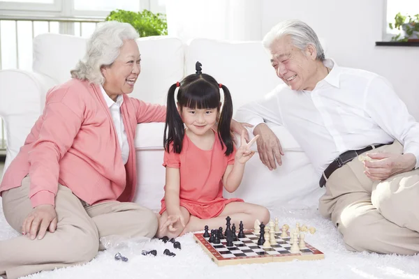 Couple with granddaughter playing — Stock Photo, Image