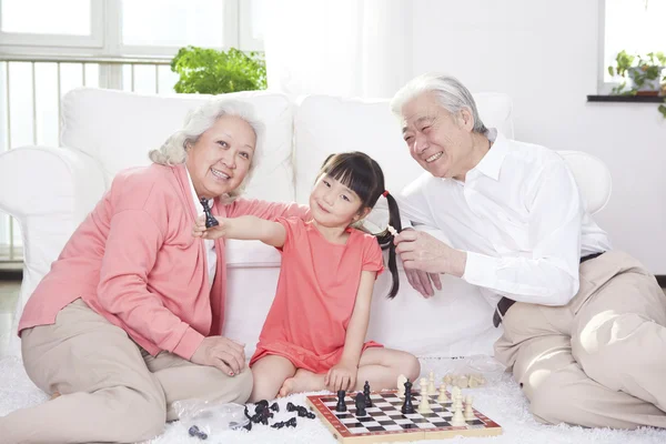Couple with granddaughter playing — Stock Photo, Image
