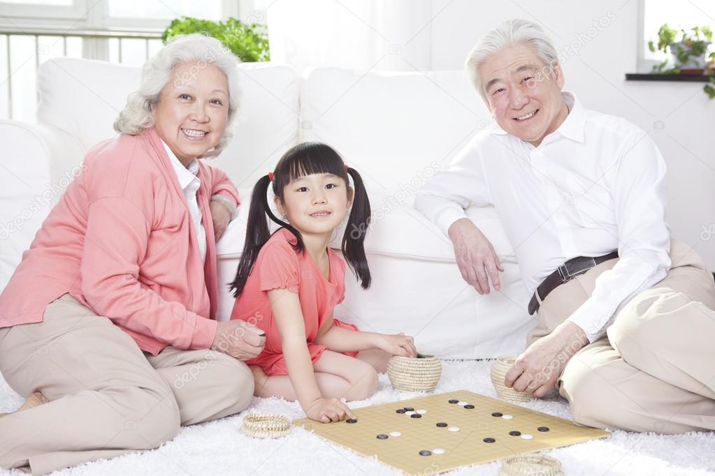 Couple with granddaughter playing