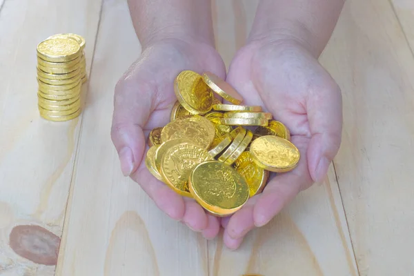 Golden coins money  in hand on background.