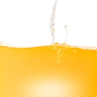 Yellow water surface with splash and air bubbles .