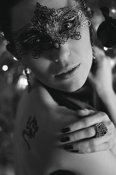 Portrait of misterious young woman in black mask