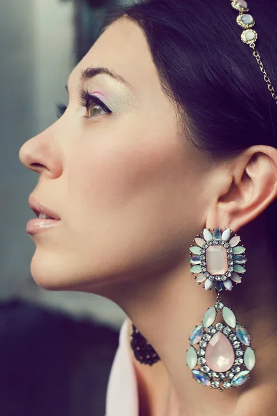 Portrait of beautiful young woman with tiara and earrings. Stock Picture