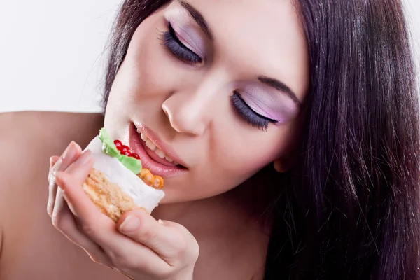 Portrait of girl. Emotions. Eating cake. — Stock Photo, Image