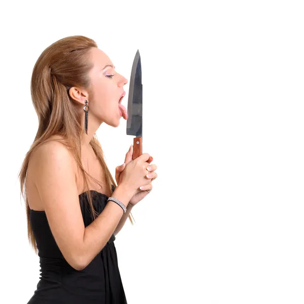 Woman licking knife — Stock Photo, Image