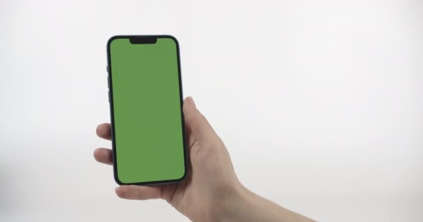 Yeşil Ekranlı Akıllı Telefonu Tutan Yukarı Kaydıran Kadın Beyaz Arkaplanda — Stok video
