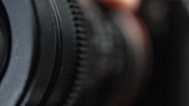 Camera Lens Rotates and the Aperture Blades Open. Flare on Optical Lens Glasses