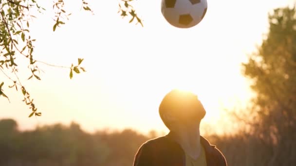 Silhouette Man Throws Kicks Ball His Head Sunset Background Slow — Vídeos de Stock
