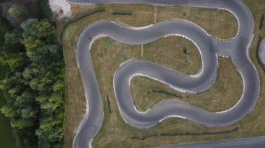 Sürücü yarışırken, go kart pistinin çarpıcı hava görüntüsü.