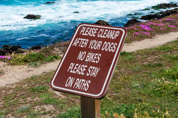 Please Clean Up After Your Dog, No Bikes, Please stay on paths warning signs along coastal trail.