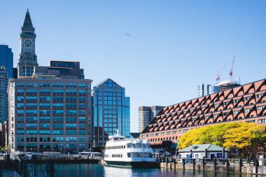 View of Buildings and waterfront with a charter boat docked in Boston Harbor
