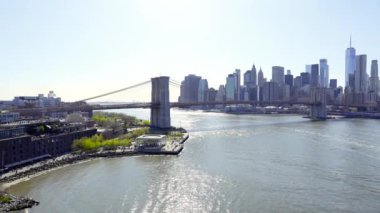 New York City skyline with skyscrapers. Brooklyn bridge over East River connecting Manhattan and Brooklyn