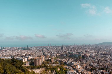 Aerial view of Barcelona city on a sunny day. Residential buildings and streets in the distance
