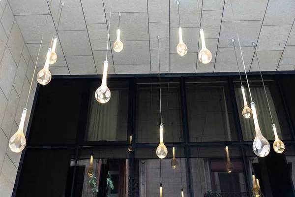 round long decorative lamp hanging from the ceiling. Exterior building architectural feature