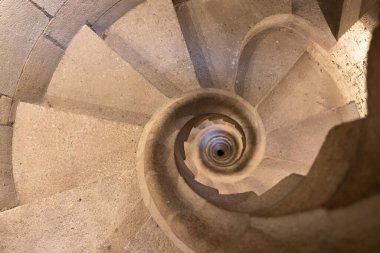 Top view of the spiral staircase in the tower. Walking down old the winding stairs