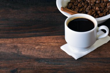 white cup with coffee and grains
