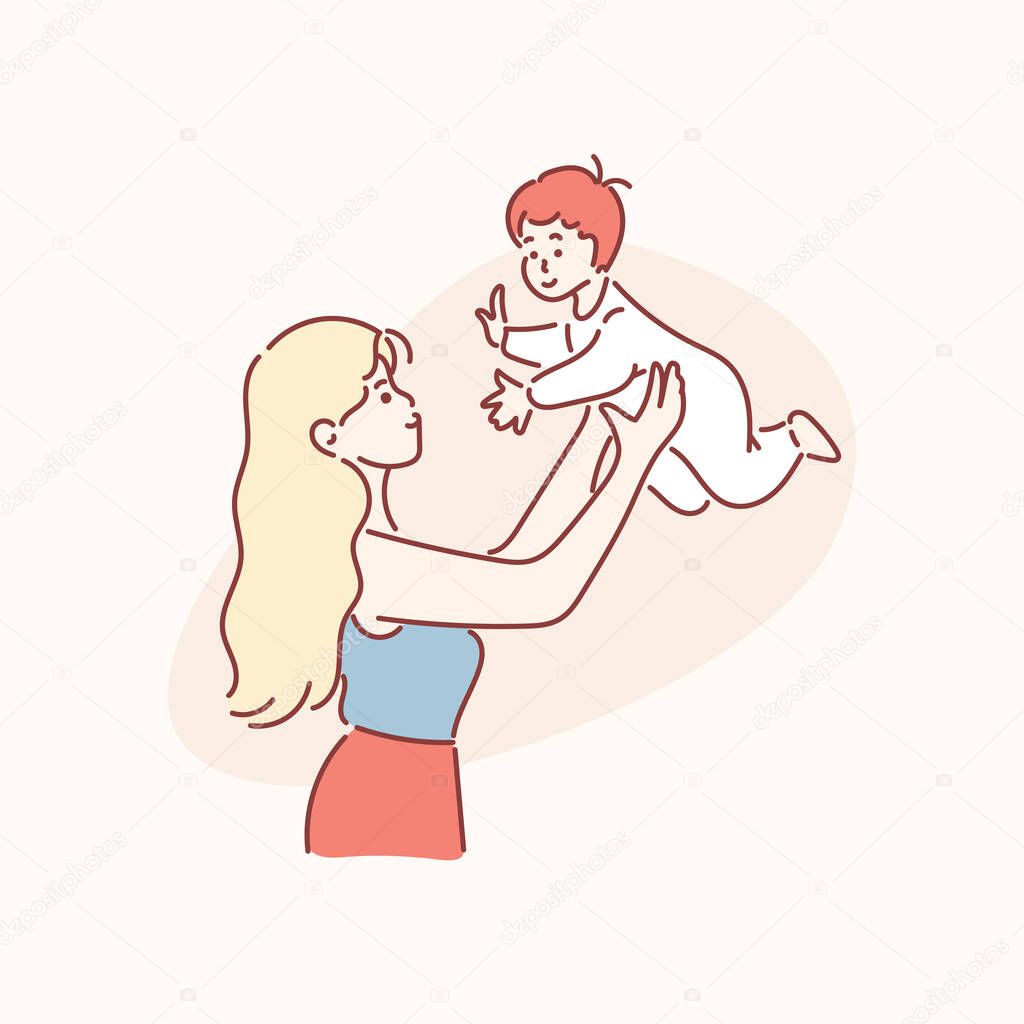 Mother picks up toddler boy on arms laughing up. Concept of motherhood