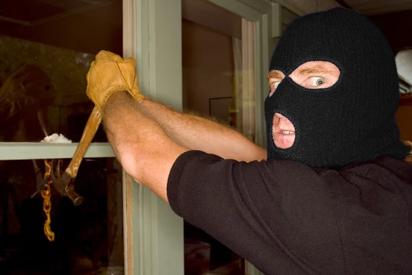 A burglar robbing a house wearing a balaclava. — Stock fotografie