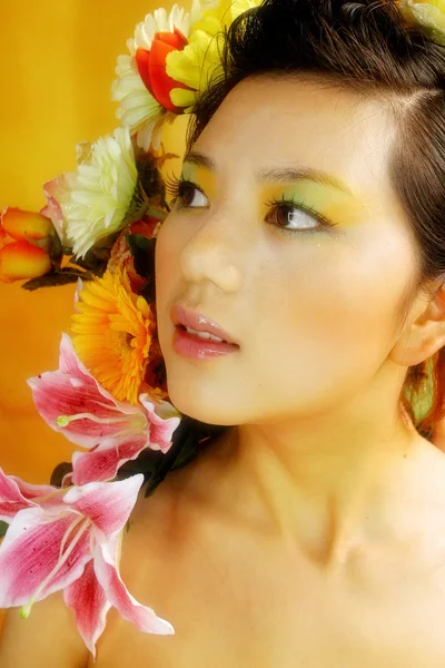 Asian woman with flowers — Stock Photo, Image