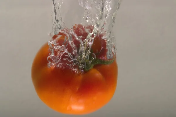 Persimmon in water splash — Stock Photo, Image