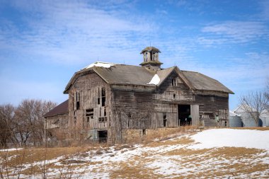 Eski ahşap ahır 1882 'de güneşli ama soğuk bir kış gününde inşa edilmiş. LaSalle County, Illinois, ABD.