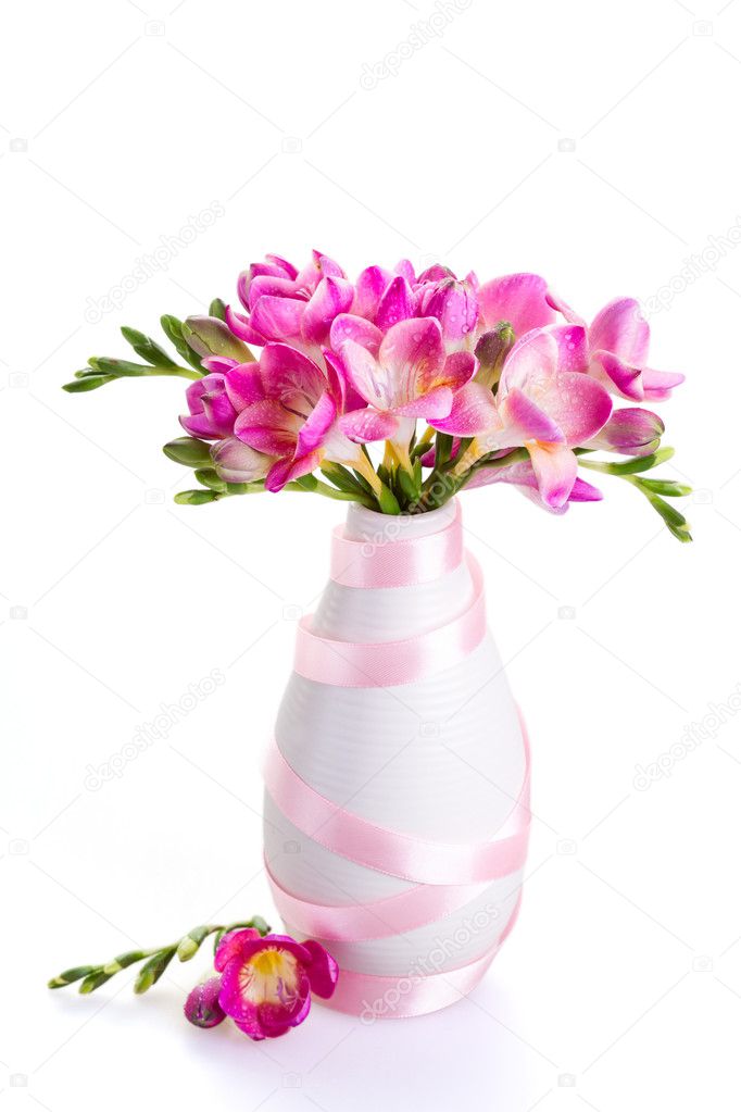 Pink Flowers In A White Vase Decorated With Ribbon Stock Photo