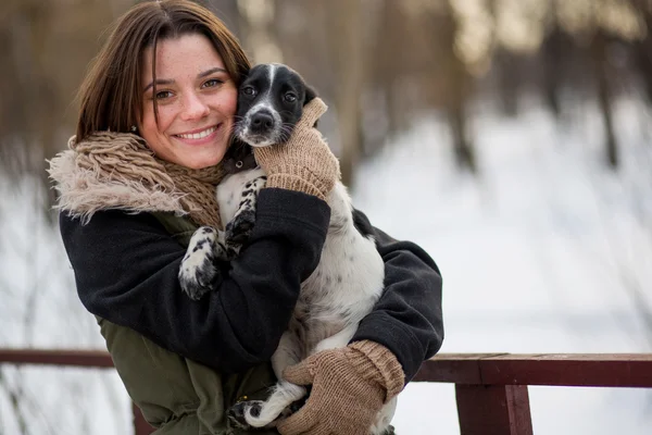 kucağında bir köpekle gülümseyen kız