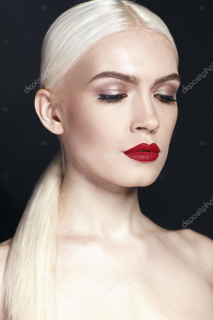 Portrait of beautiful girl wih blonde hair close up isolated on black background
