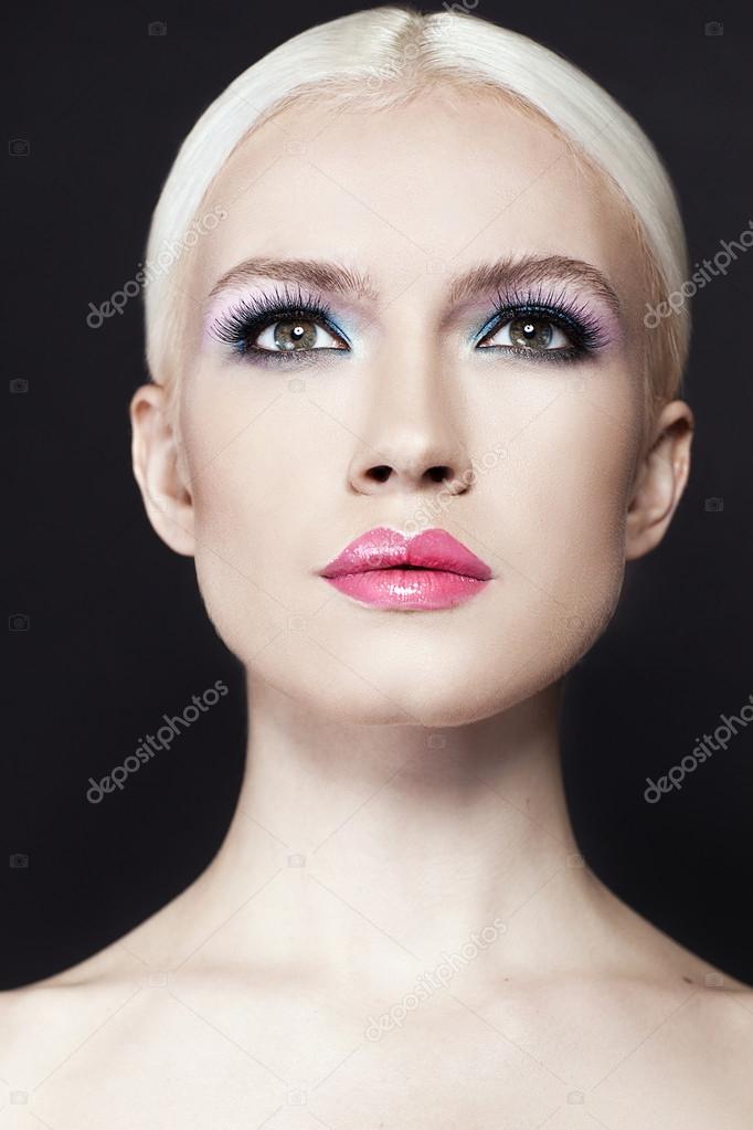 Portrait of beautiful girl wih blonde hair close up isolated on black background
