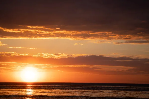 Sunset over the sea horizon. Sun set over sea. Sea sunset landscape. Sea horizon at sunset